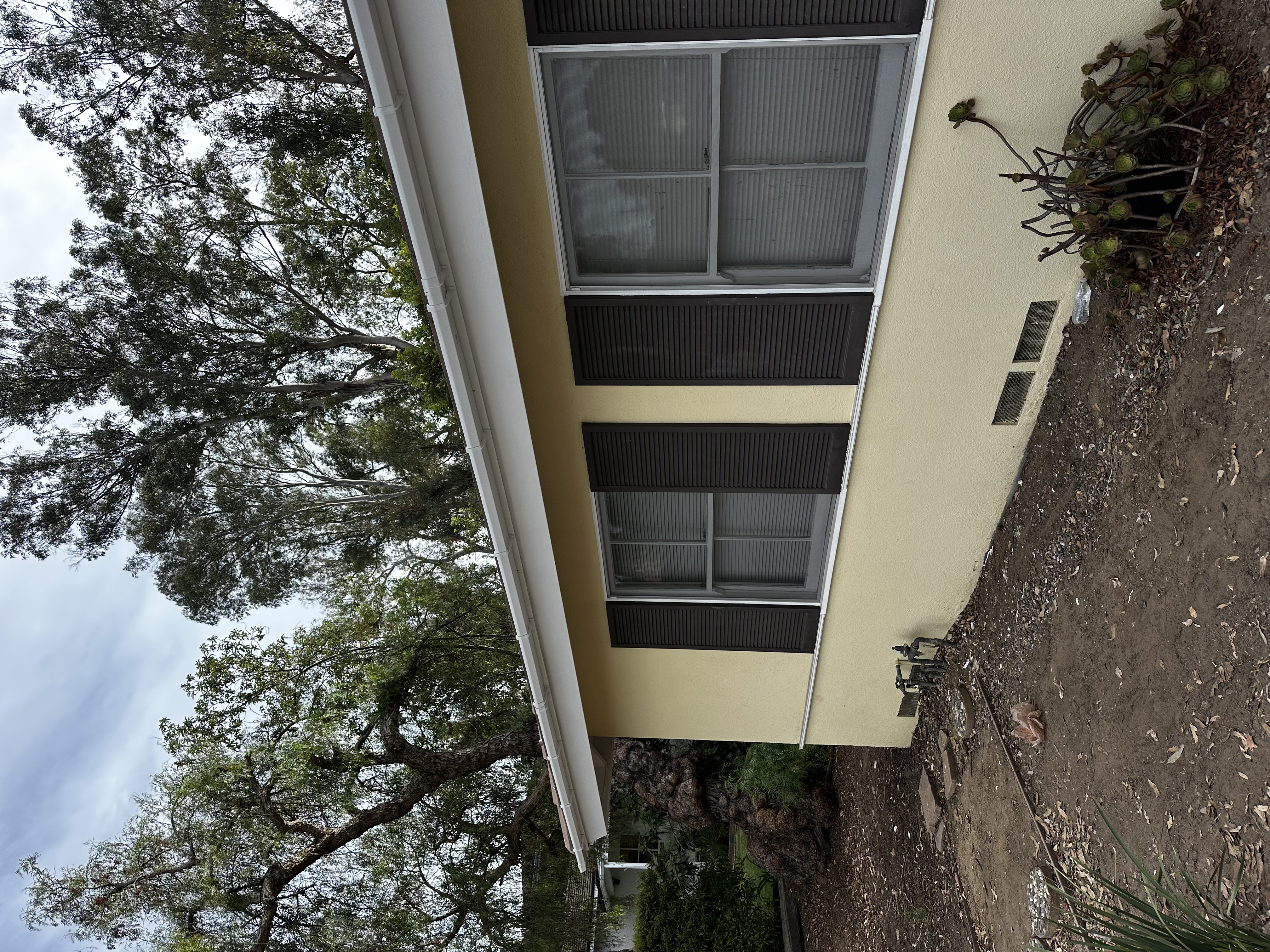 New gutters and downspouts installed along home exterior